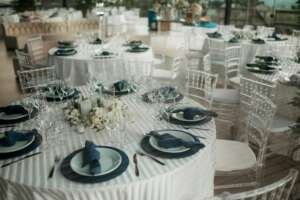 Beautifully arranged tables with elegant decor at an indoor wedding reception.